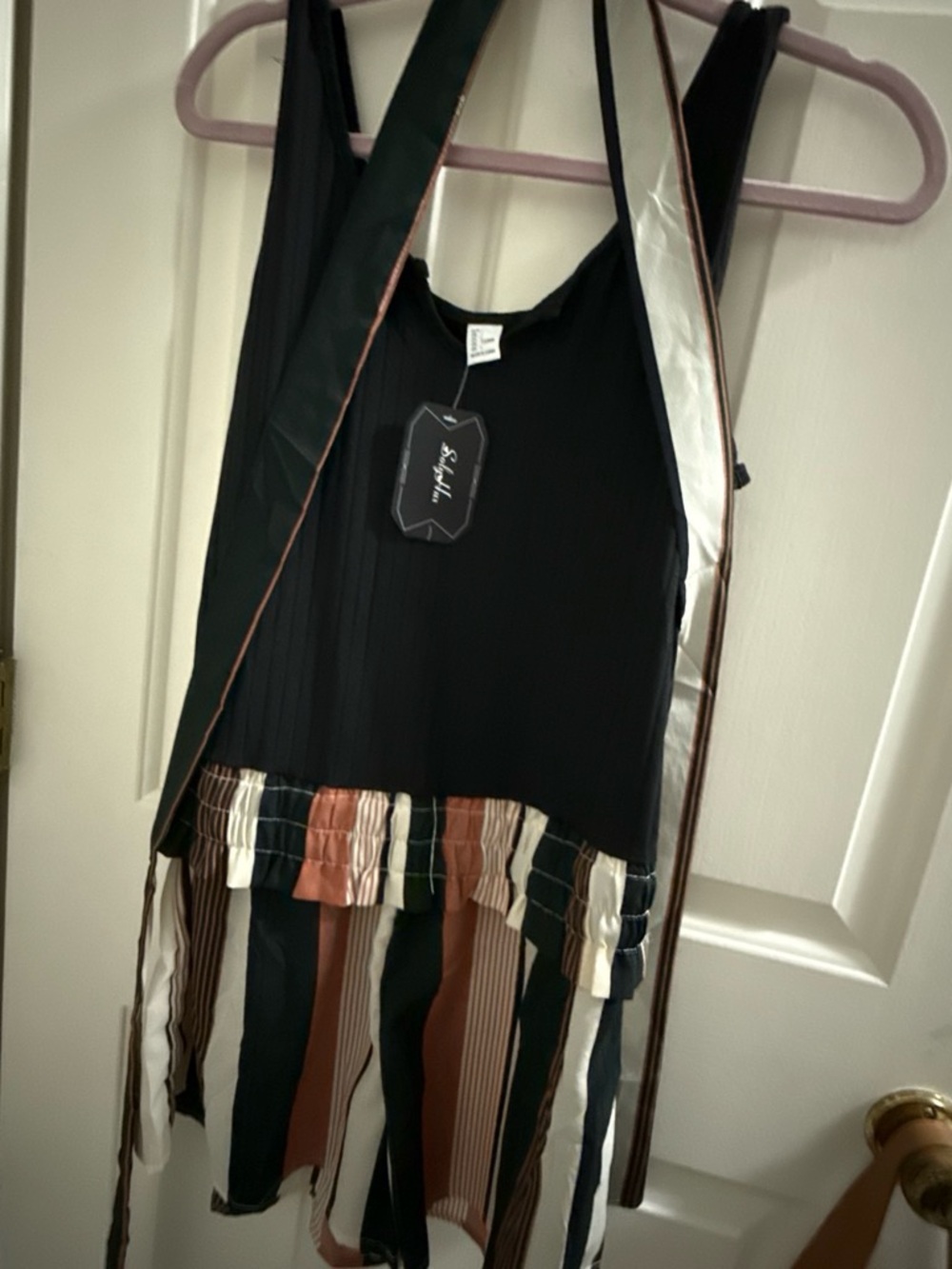 Black Striped Layered romper with Rust and Cream Accents. Has belt